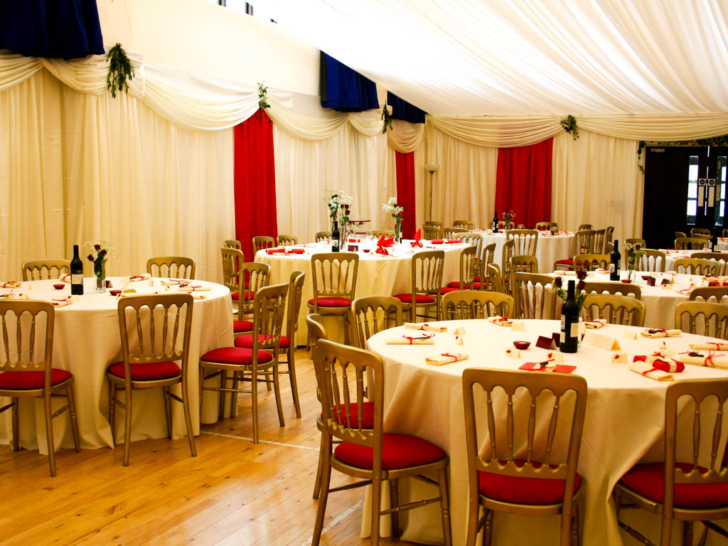 Cream Drapes with Red Flashes Hired Tables and Chairs