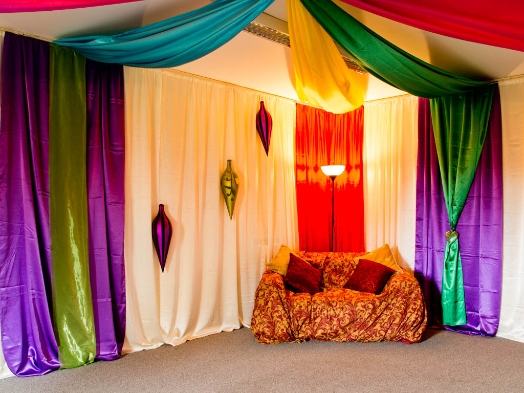Cream drapes with satin multicoloured flashes hall sofa
